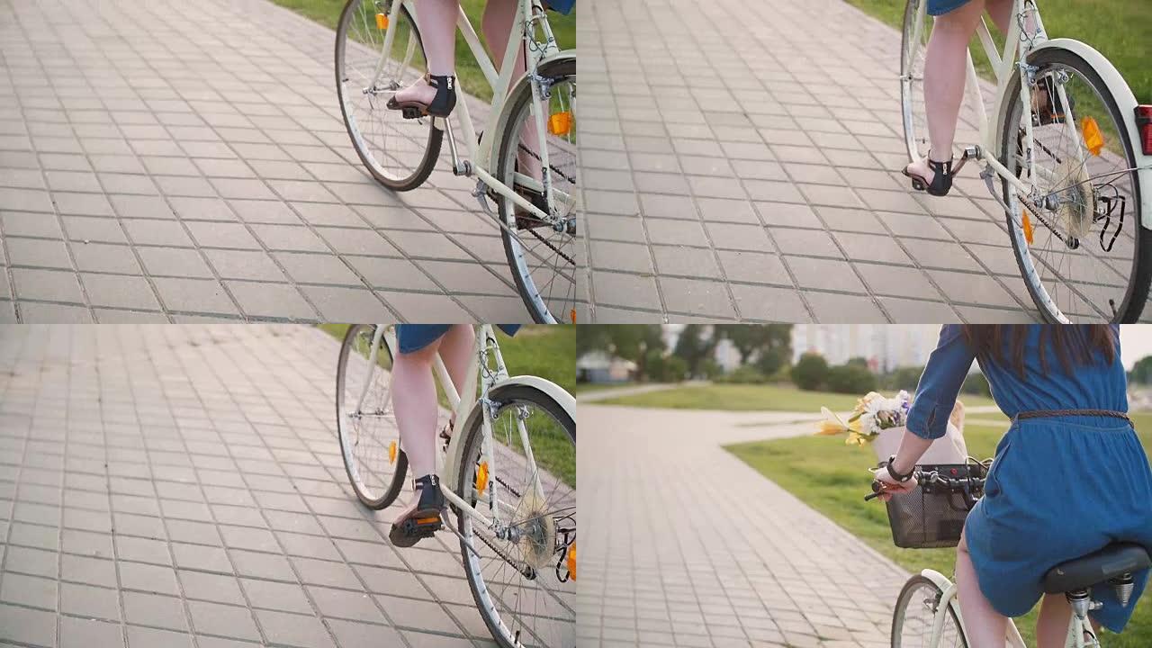 女孩的腿踩着脚，骑着自行车，穿着黑色的夏季鞋和裙子，慢动作，steadicam射击
