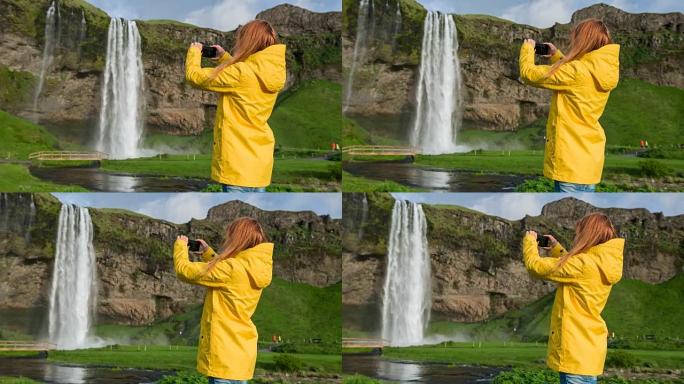 冰岛游客为Seljalandsfoss瀑布拍照