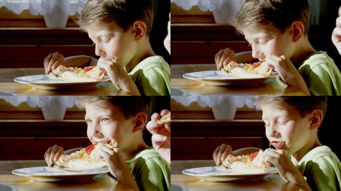 年轻男孩吃披萨