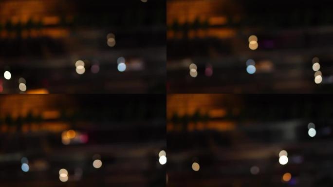 4k镜头，从顶部看，从汽车上看，道路上的交通模糊散焦光，夜间从汽车上看