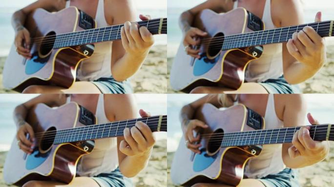 女人在沙滩上弹吉他