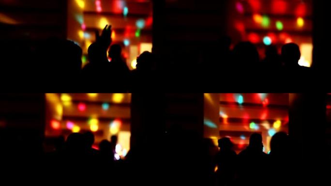 俱乐部灯光表演背景上跳舞的人的剪影