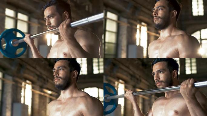 肌肉裸男用力举起沉重的杠铃，在工业健身房做二头肌弯曲/健身运动。