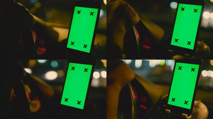 人们晚上在汽车上使用智能手机，绿屏