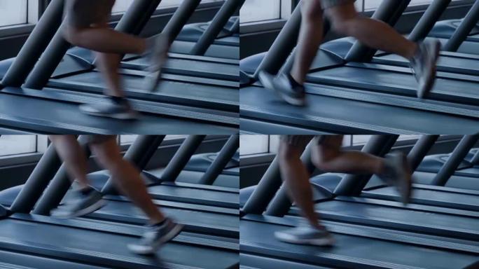 亚洲男子在健身房跑步机上跑步