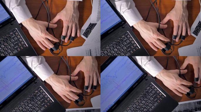 测谎仪测试。在测谎仪测试过程中，人握手和笔记本电脑。4K。