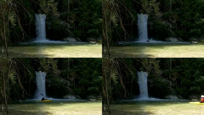 慢动作: 男子在汹涌的白水瀑布中划着皮划艇