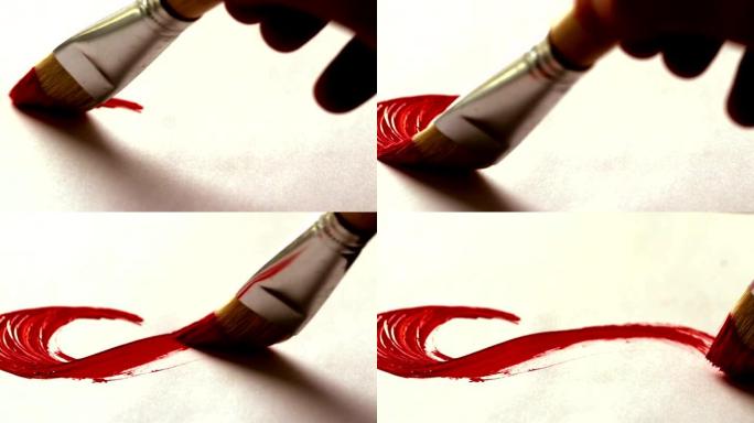 画家用红色油漆和画笔绘画