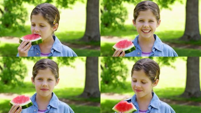 可爱的小女孩在公园吃西瓜