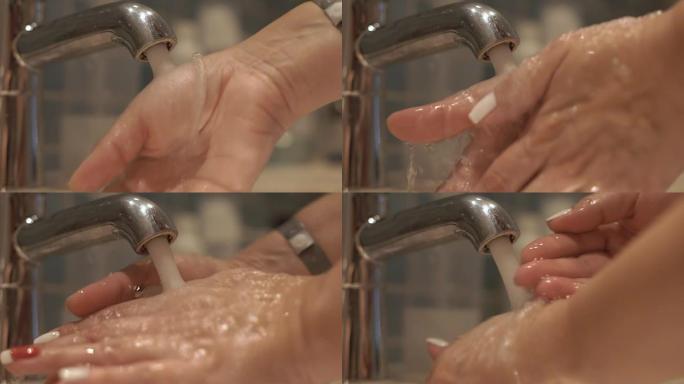 女人在水龙头里洗手