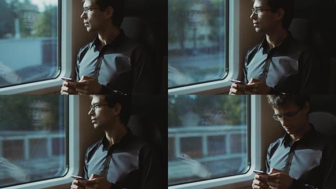 男子在火车上旅行时使用电话
