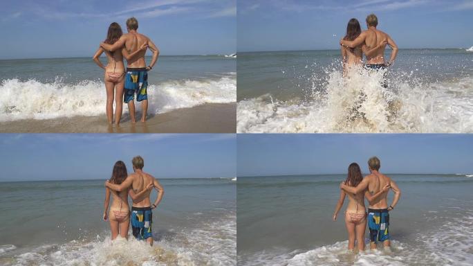 慢动作: 年轻夫妇在海滩上拥抱