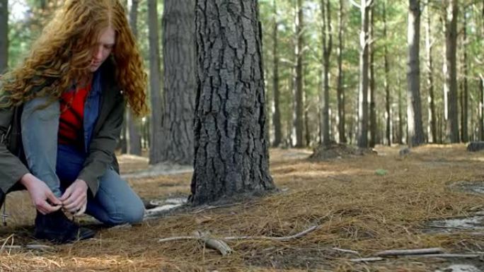 女人在森林里系鞋带4k