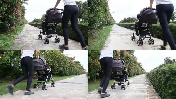 母亲和婴儿车里的男婴一起慢跑。