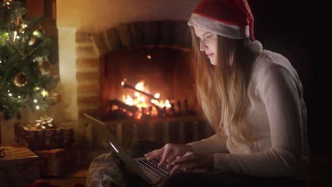 DS年轻女子在壁炉旁使用笔记本电脑