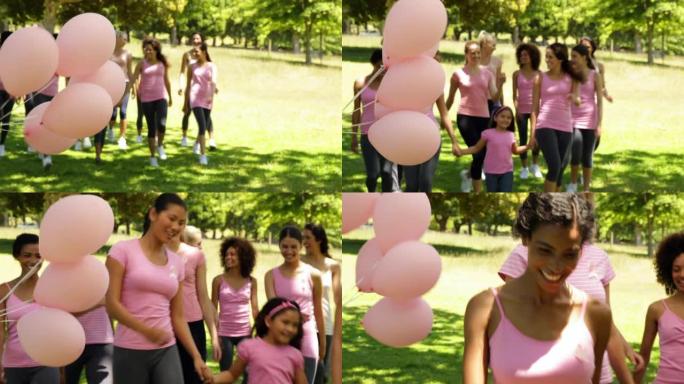 快乐的女人去散步以提高对乳腺癌的认识
