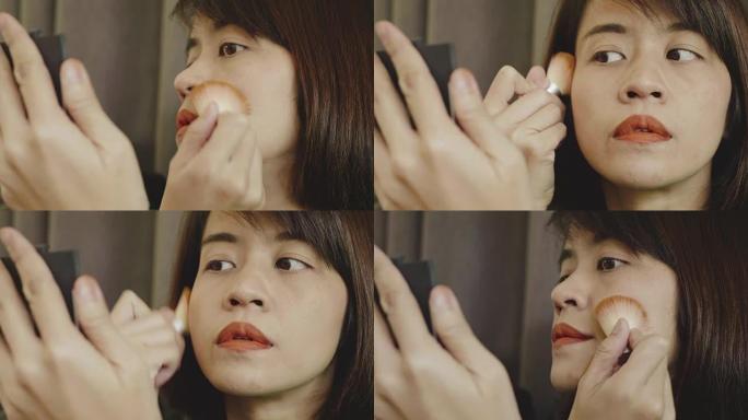 亚洲妇女使用化妆粉