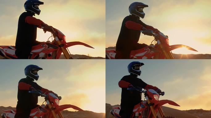 专业FMX摩托车骑手准备开始驾驶他的摩托车在坚硬的沙地越野地形。太阳设置。