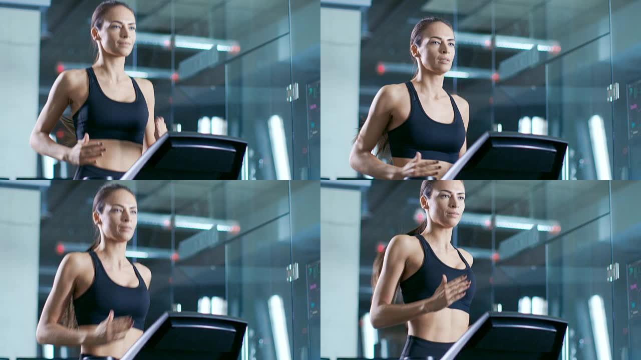 在科学运动实验室中，美女运动员在跑步机上行走，电极附着在她的身体上，监视器显示EKG数据。慢动作。低