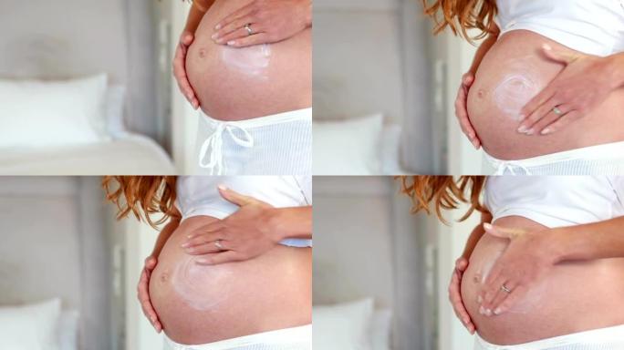 孕妇在肚子上擦奶油