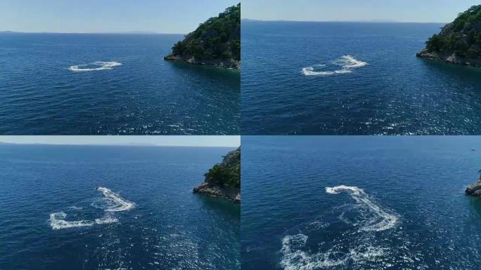 在美丽的海湾和蓝色海水和热带岛屿中进行极端喷气滑雪的鸟瞰图