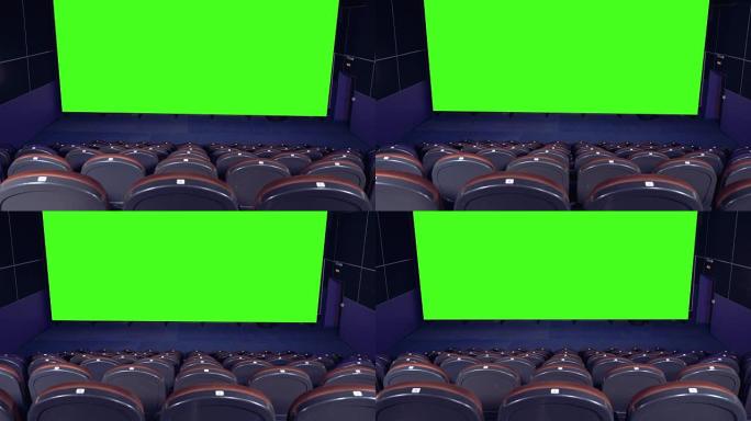 空旷的电影院大厅中带有绿色屏幕背景的空白电影院屏幕。