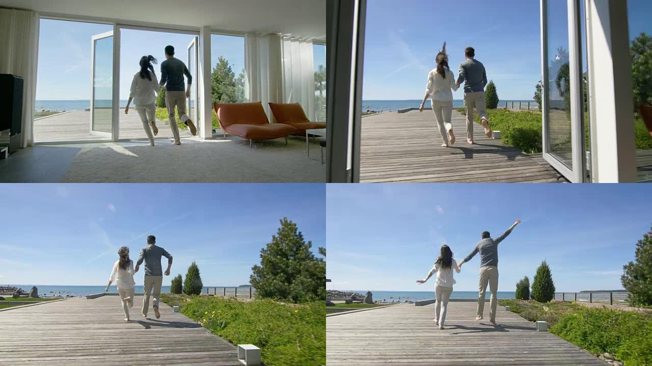 幸福的年轻夫妇牵着手跑出家门，走到海边的露台上。