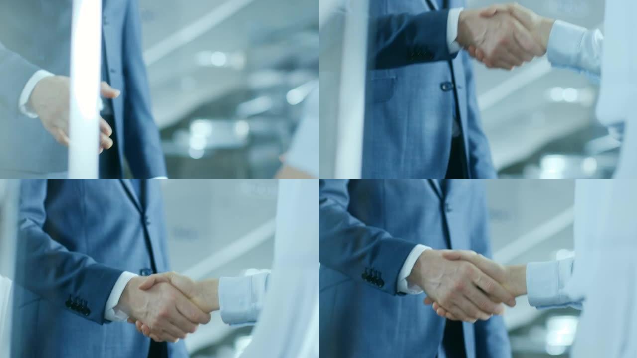 女商人和商人握手的特写镜头，重点是握手。