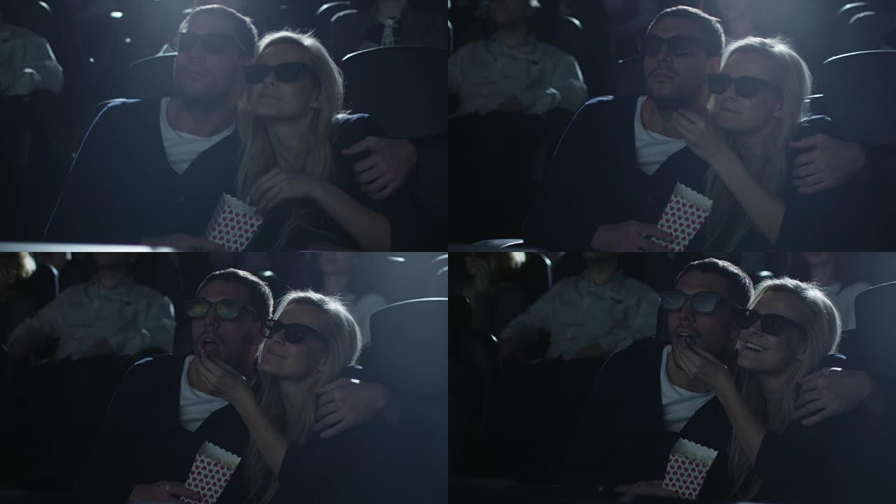 夫妻在电影院看5d电影放映时互相拥抱。