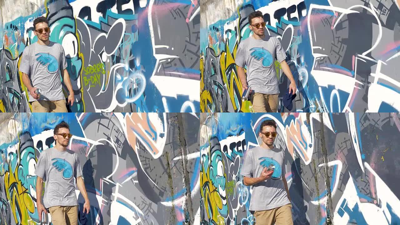 一位男性涂鸦艺术家沿着粉刷过的墙壁行走。