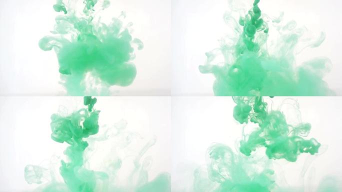 明亮多彩的背景。绿色液体墨水在水中混色