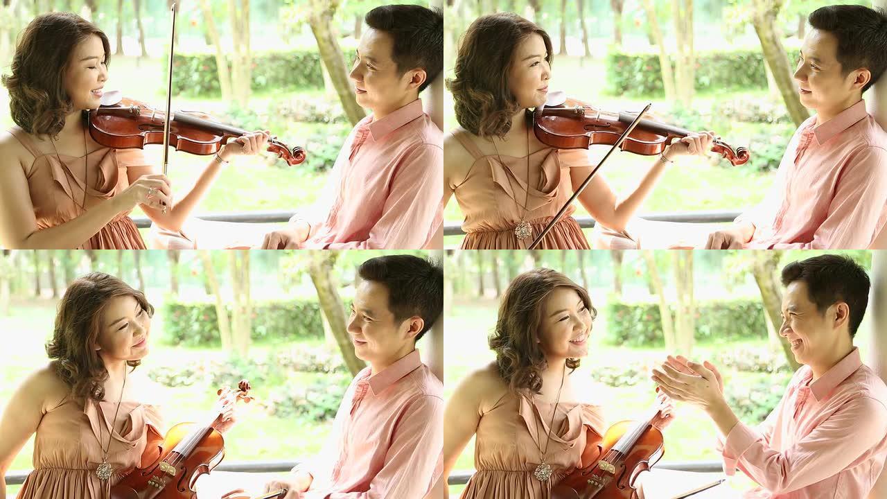 多莉：亚洲女小提琴手拉小提琴，男友在听