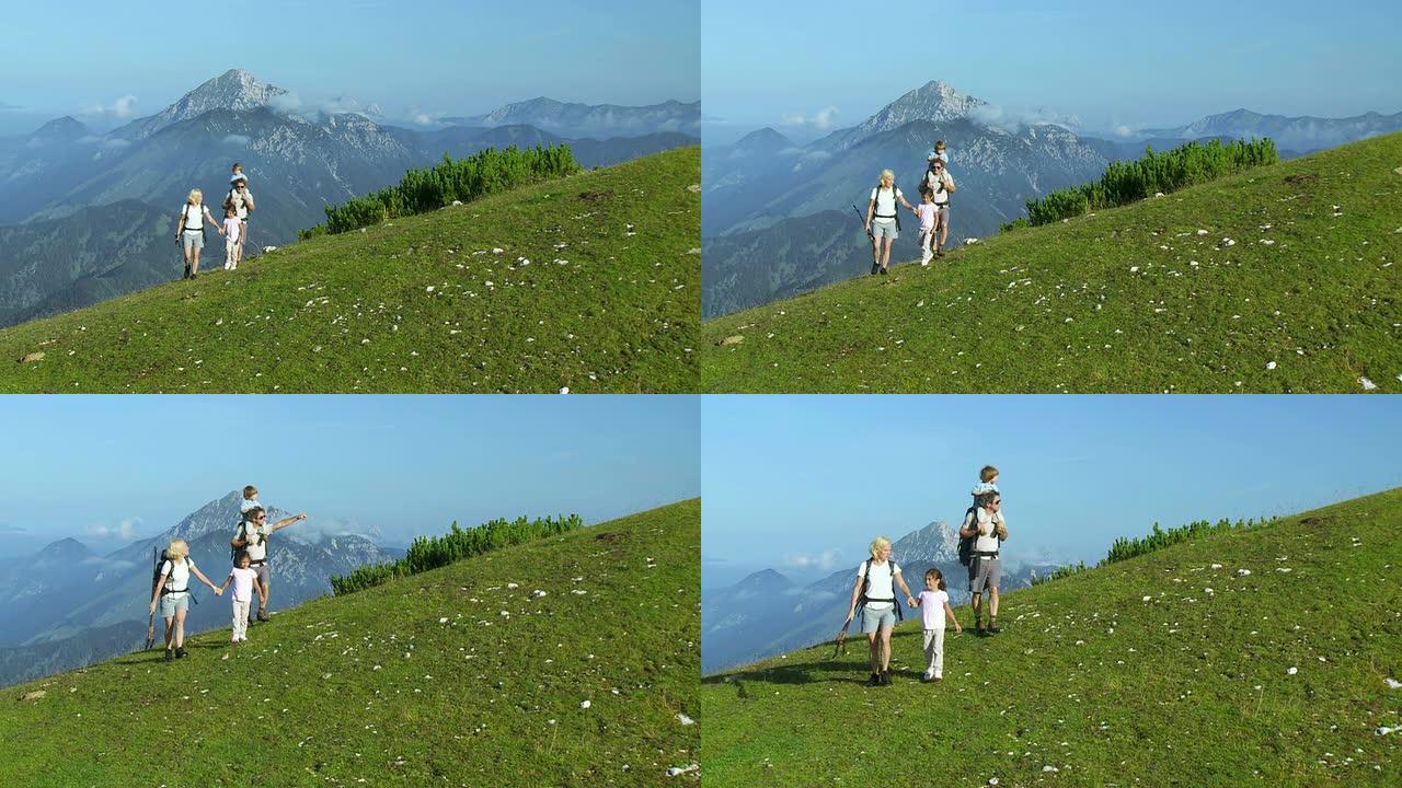 高清起重机: 一家人走在绿山上