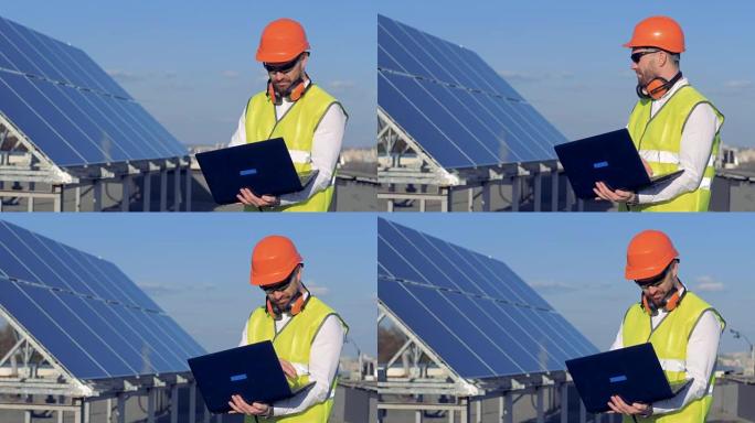 太阳能电池和一个男性建造师在附近使用笔记本电脑。生态节能理念。