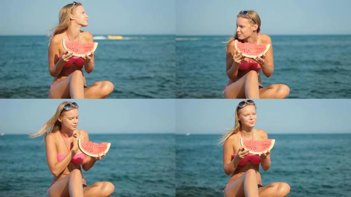 迷人的金发女人在海滩上吃西瓜