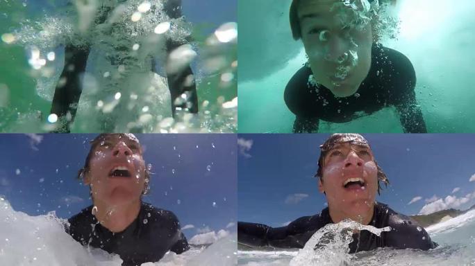 慢动作特写: 快乐的年轻冲浪者鸭子在波浪下潜水