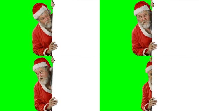 惊讶的圣诞老人躲在绿屏后面