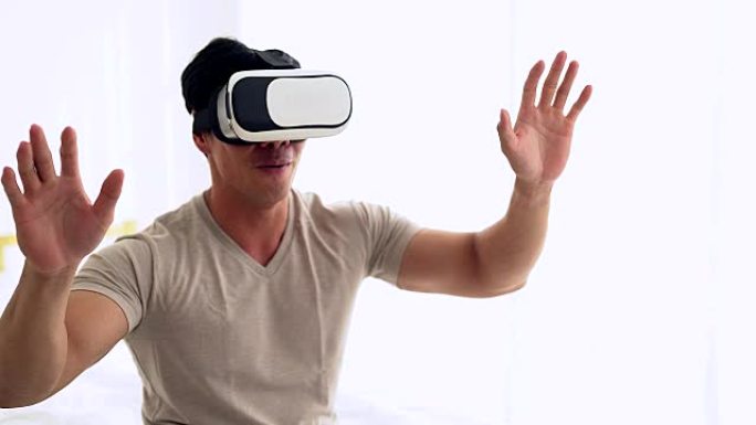 戴着虚拟现实眼镜的年轻人。与VR护目镜耳机一起使用的智能手机。