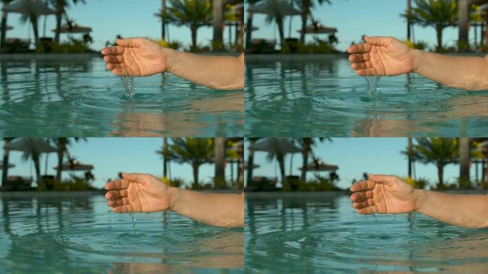 慢动作: 无法辨认的女人sc起水，然后将其洒回游泳池。