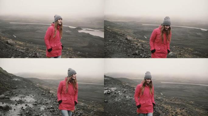 年轻迷人的女人独自走在火山黑山。游客探索冰岛，去冰泻湖