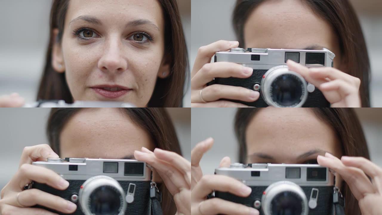 年轻迷人的女人用经典的测距仪胶片相机拍照，看着相机微笑。