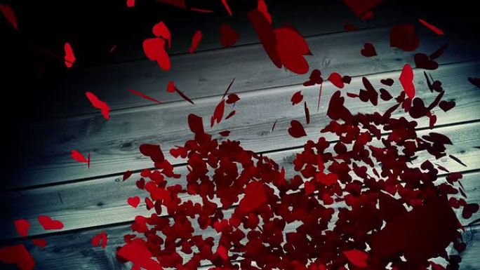 红色的心落在带有情人节信息的木制表面上