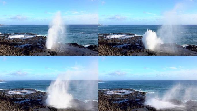 慢动作: 强大的海浪在岩石海岸的气孔中飞溅