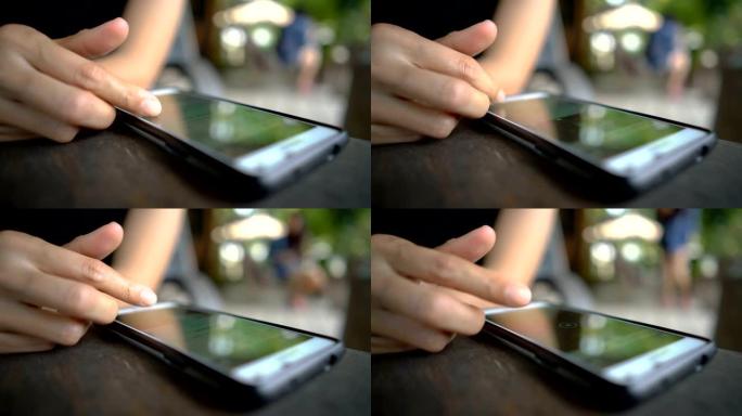 咖啡店智能手机屏幕上的女性滑动手指。