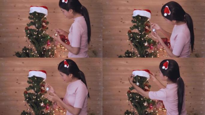 女性邀请圣诞树装饰，家用相机手持视频4k。