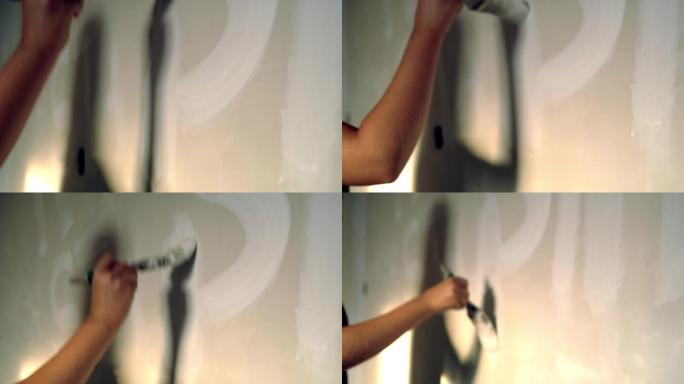 女人在墙上画白色字母，慢动作