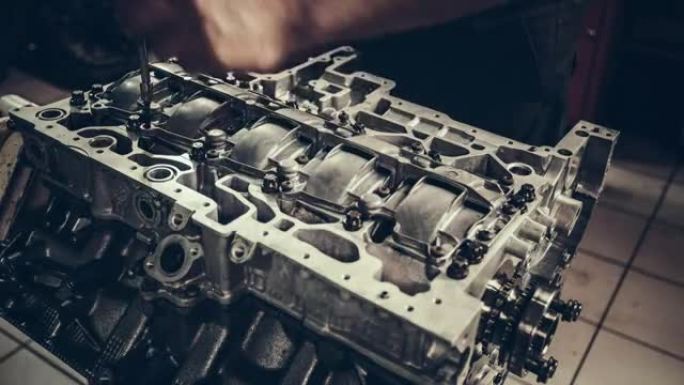 Professional mechanic repairing V10 engine in auto