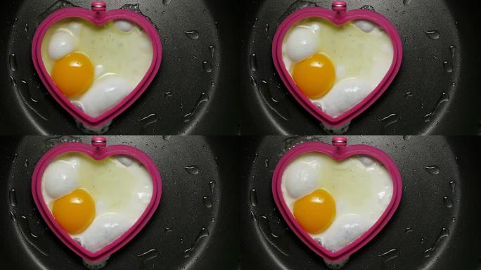 煎锅里的鸡蛋。心脏的形式。
