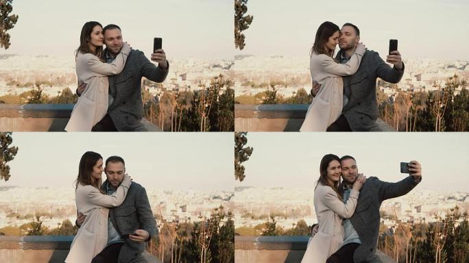 年轻美丽的夫妇在意大利罗马的全景下拍摄自拍照片。快乐的男人亲吻女人并拥抱