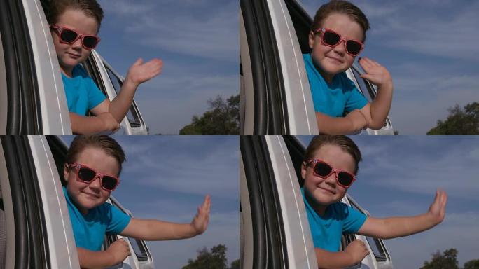 快乐的孩子在慢动作中向车窗外挥手